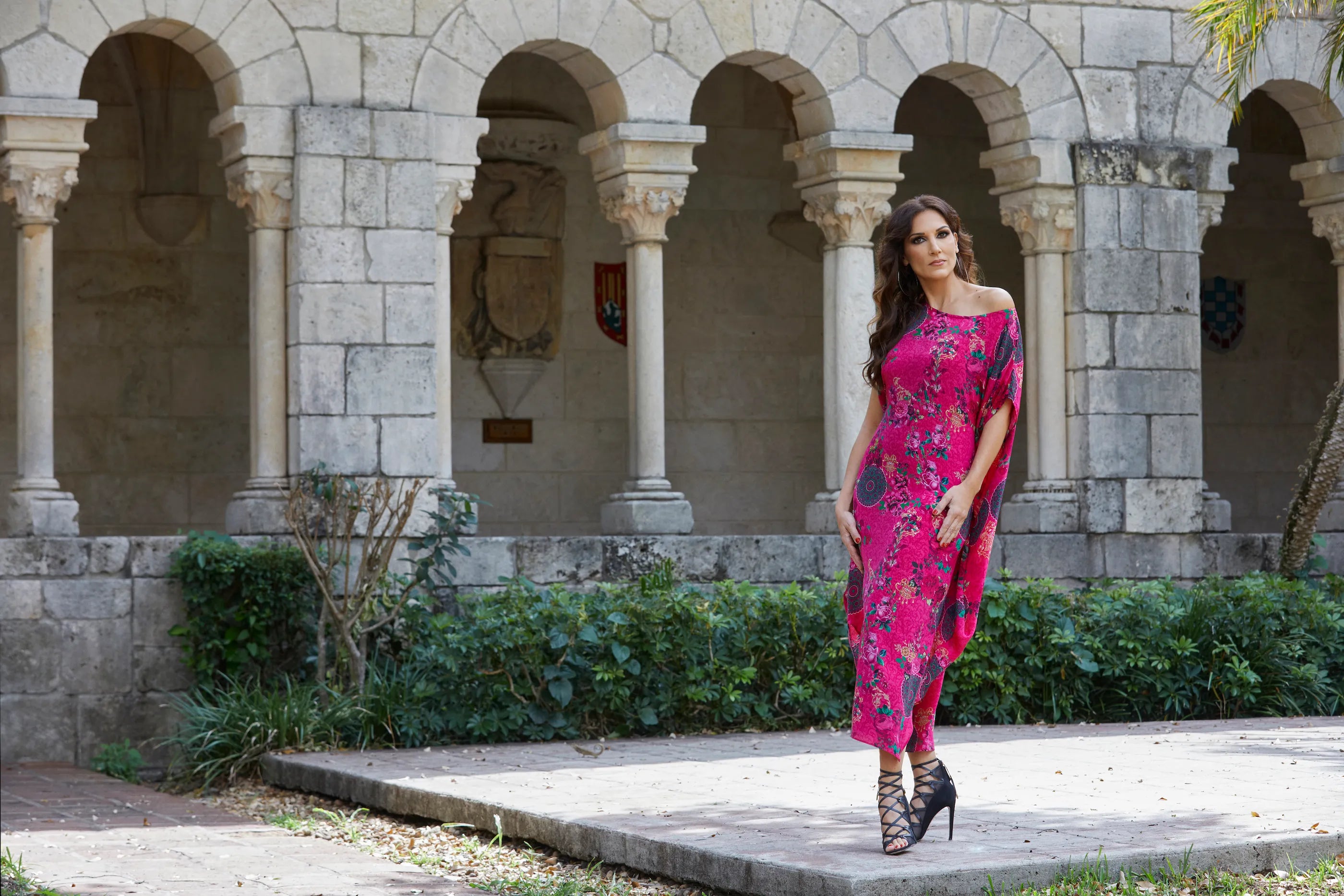 Kim Cáceres wearing a luxury silk kaftan dress in Life is Love print